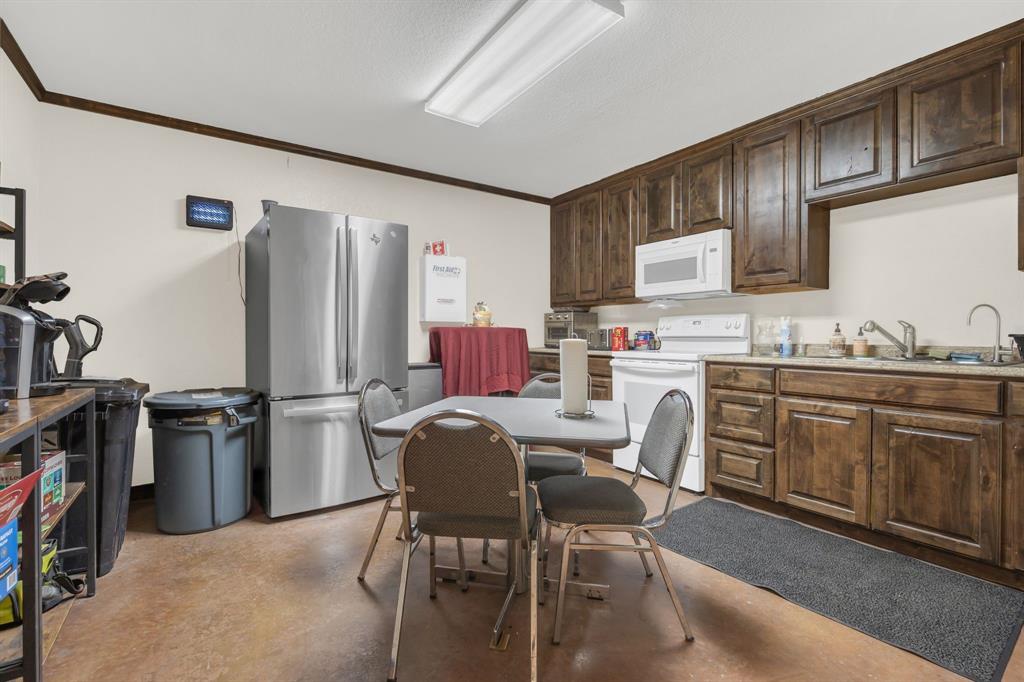 2522 Highway 287 Decatur, TX 76234 - Photo 19 of 25 a kitchen with stainless steel appliances granite countertop a refrigerator sink and stove