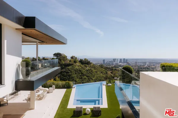 a view of a swimming pool with seating area