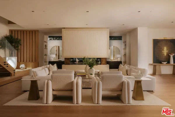 a living room with couches a coffee table and a flat screen tv