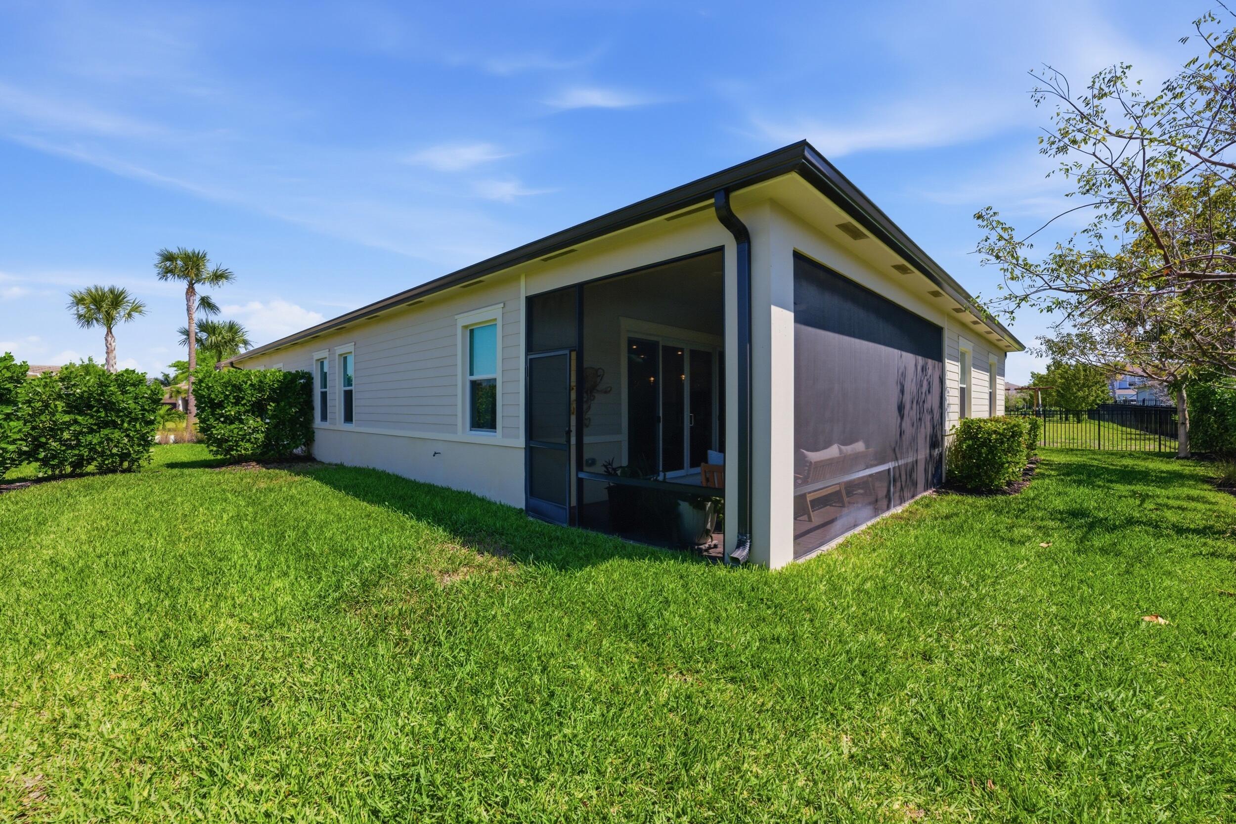 19230 Rolling Acres Road Loxahatchee, FL 33470 - Photo 38 of 58 a view of a house with backyard and garden