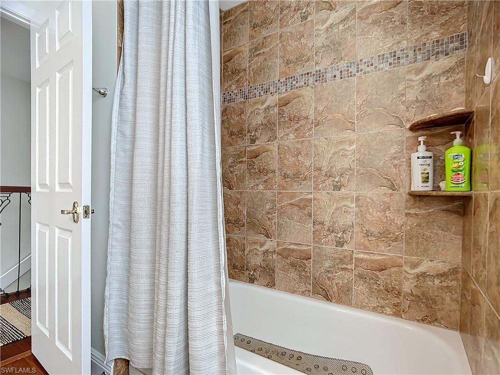 2860 Citrus Lake Drive, Unit R202 Naples, FL 34109 - Photo 30 of 50 a bathroom with a bathtub