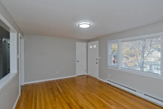 a living room with furniture a flat screen tv and a window