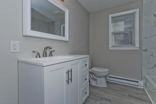 a view of an empty room and wooden floor