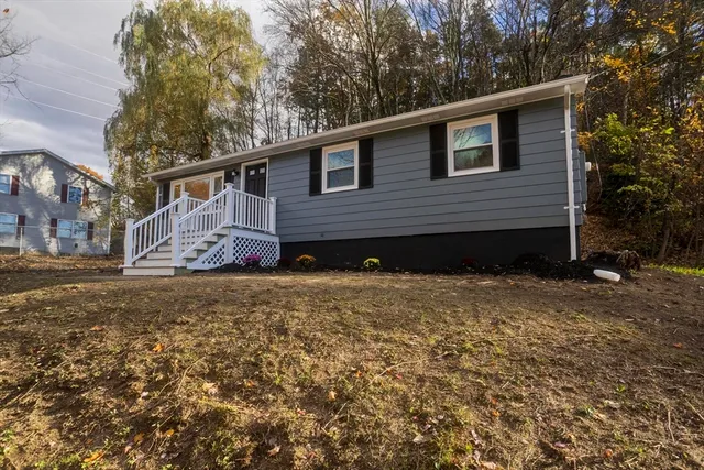 a kitchen with a refrigerator a sink and cabinets