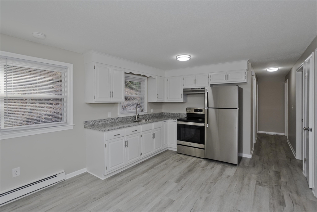 35 Ludlow Road South Hadley, MA 01075 - Photo 5 of 34 a kitchen with a refrigerator a sink and cabinets