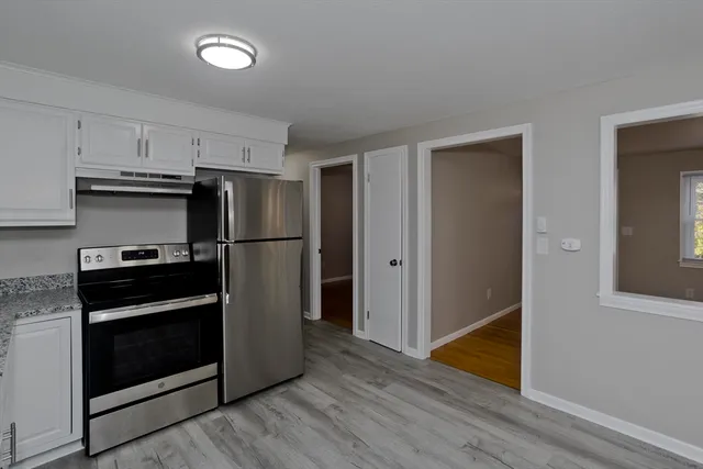 a kitchen with stainless steel appliances granite countertop a refrigerator and a stove top oven