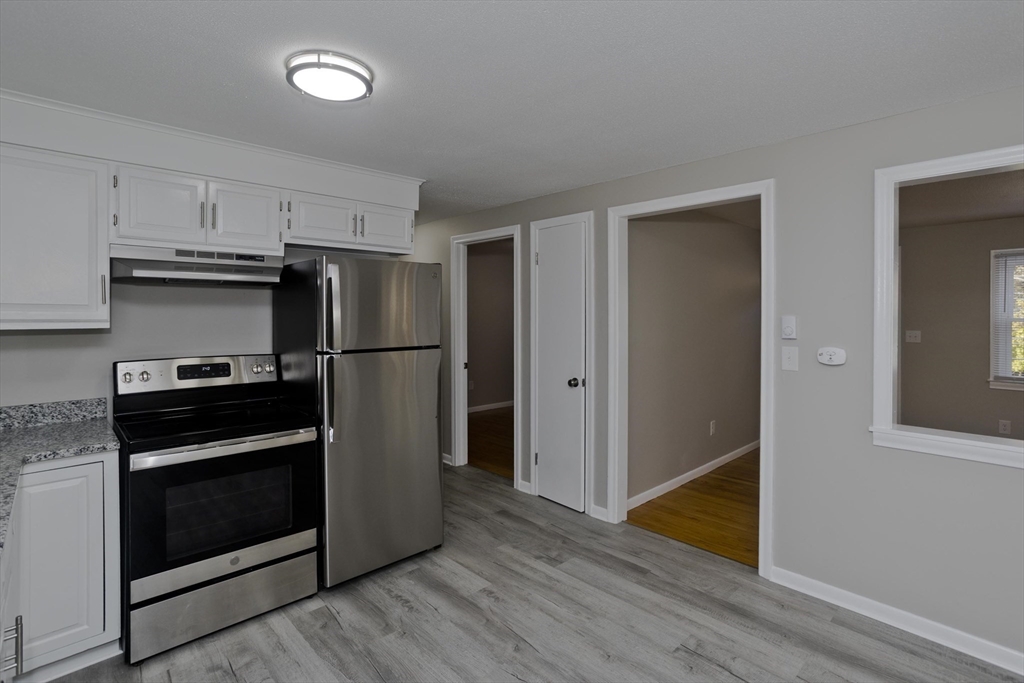35 Ludlow Road South Hadley, MA 01075 - Photo 6 of 34 a kitchen with wooden floors appliances and cabinets