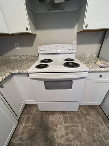 a stove top oven sitting inside of a kitchen