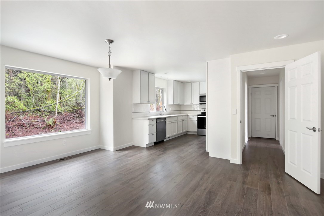 319 Whitetail Loop Blaine, WA 98230 - Photo 11 of 40 a view of a kitchen with wooden floor electronic appliances and window