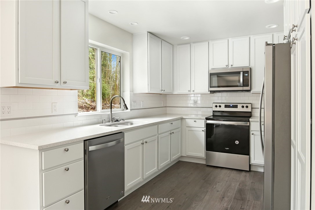 319 Whitetail Loop Blaine, WA 98230 - Photo 16 of 40 a kitchen with a sink and steel appliances