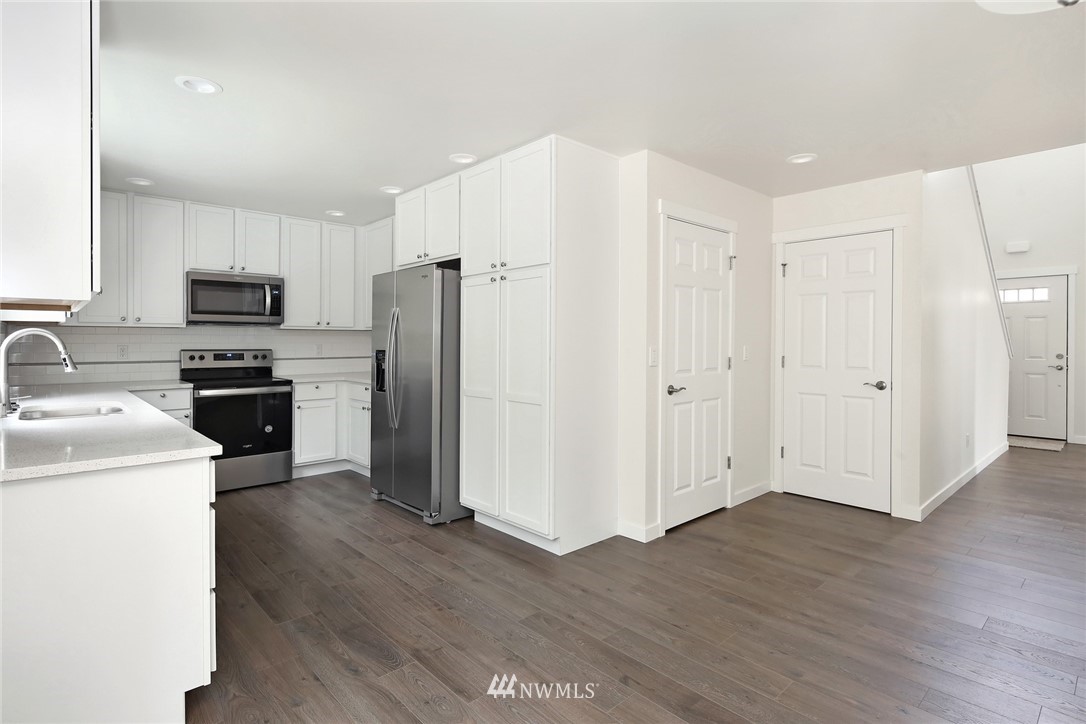 319 Whitetail Loop Blaine, WA 98230 - Photo 17 of 40 a kitchen with a refrigerator a stove top oven and wooden floor