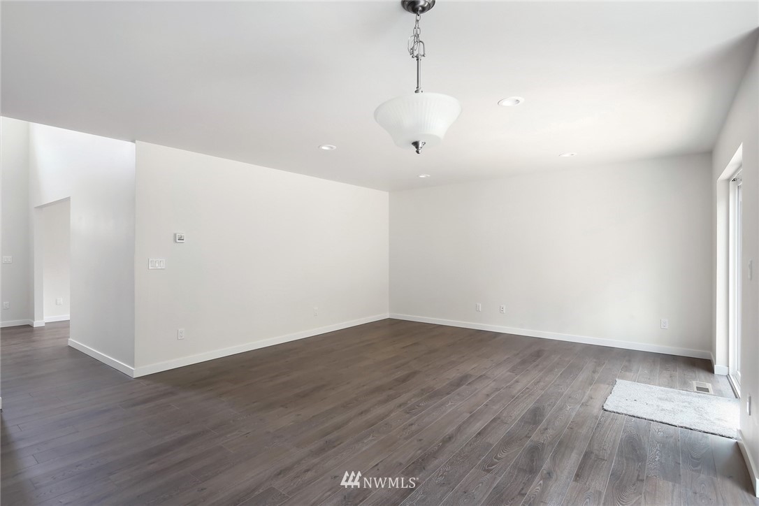 319 Whitetail Loop Blaine, WA 98230 - Photo 19 of 40 a view of an empty room with wooden floor and a window