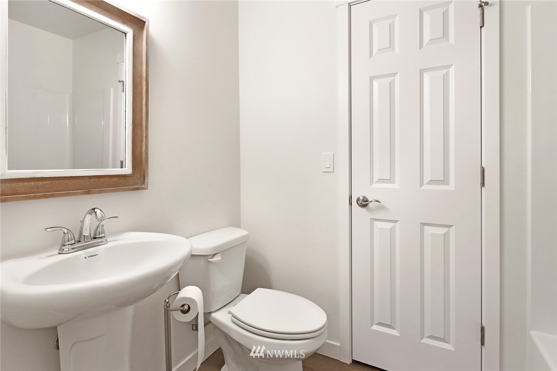 319 Whitetail Loop Blaine, WA 98230 - Photo 29 of 40 a bathroom with a sink a toilet and a mirror