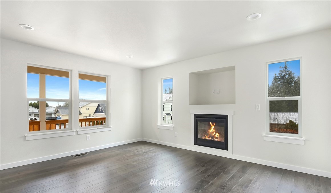 319 Whitetail Loop Blaine, WA 98230 - Photo 6 of 40 a view of an empty room with a window and fire place