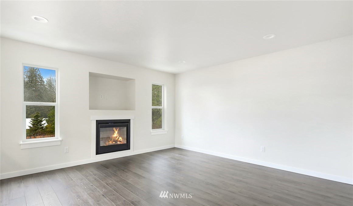 319 Whitetail Loop Blaine, WA 98230 - Photo 7 of 40 a view of an empty room with window and fire place