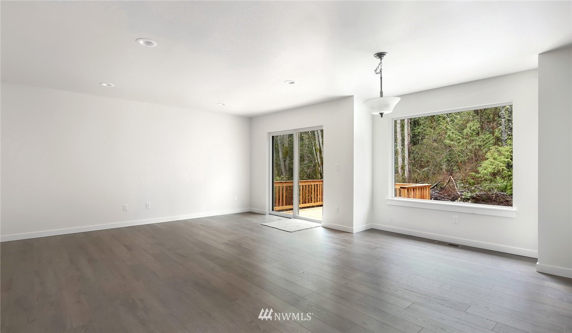 319 Whitetail Loop Blaine, WA 98230 - Photo 9 of 40 an empty room with wooden floor and windows