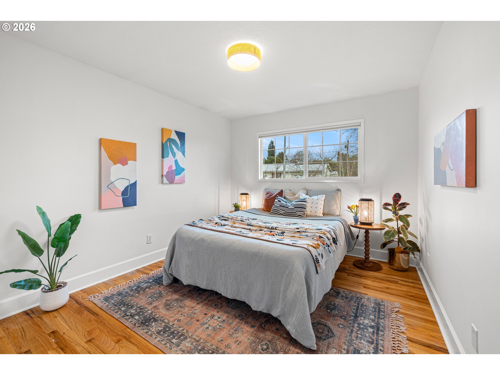 1744 Northeast 153rd Place Portland, OR 97230 - Photo 18 of 33 a spacious bedroom with a bed and a painting on the wall