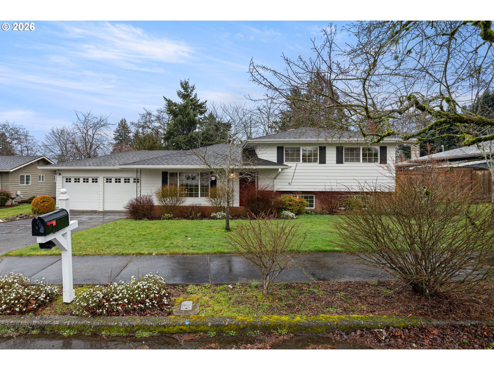 1744 Northeast 153rd Place Portland, OR 97230 - Photo 3 of 33 a front view of a house with a yard and garage