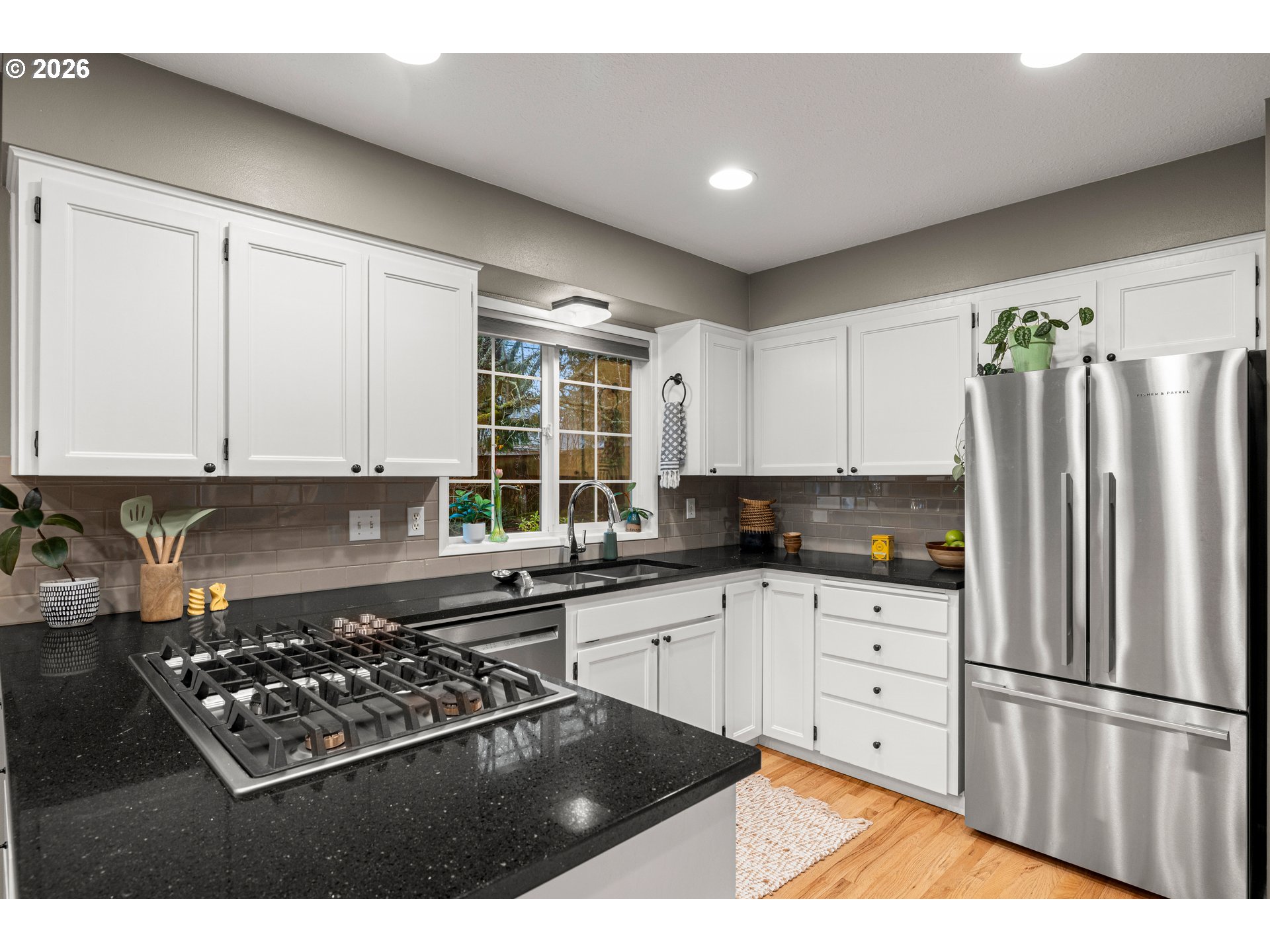 1744 Northeast 153rd Place Portland, OR 97230 - Photo 9 of 33 a kitchen with stainless steel appliances a stove a refrigerator and cabinets