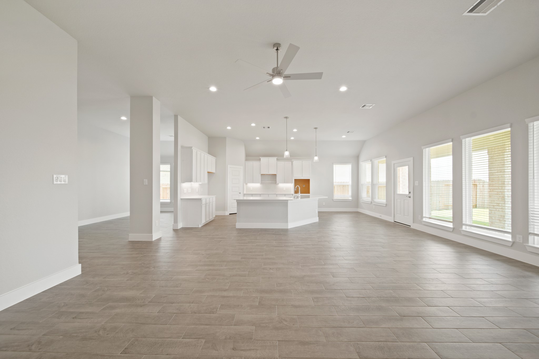 405 Hampton Edge Lane Waller, TX 77484 - Photo 12 of 45 a view of an empty room with a kitchen view and a window