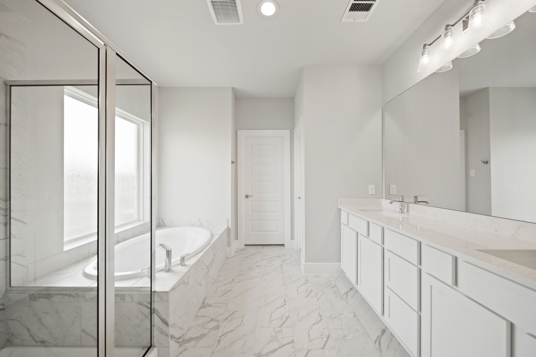 405 Hampton Edge Lane Waller, TX 77484 - Photo 18 of 45 a spacious bathroom with a double vanity sink and a mirror