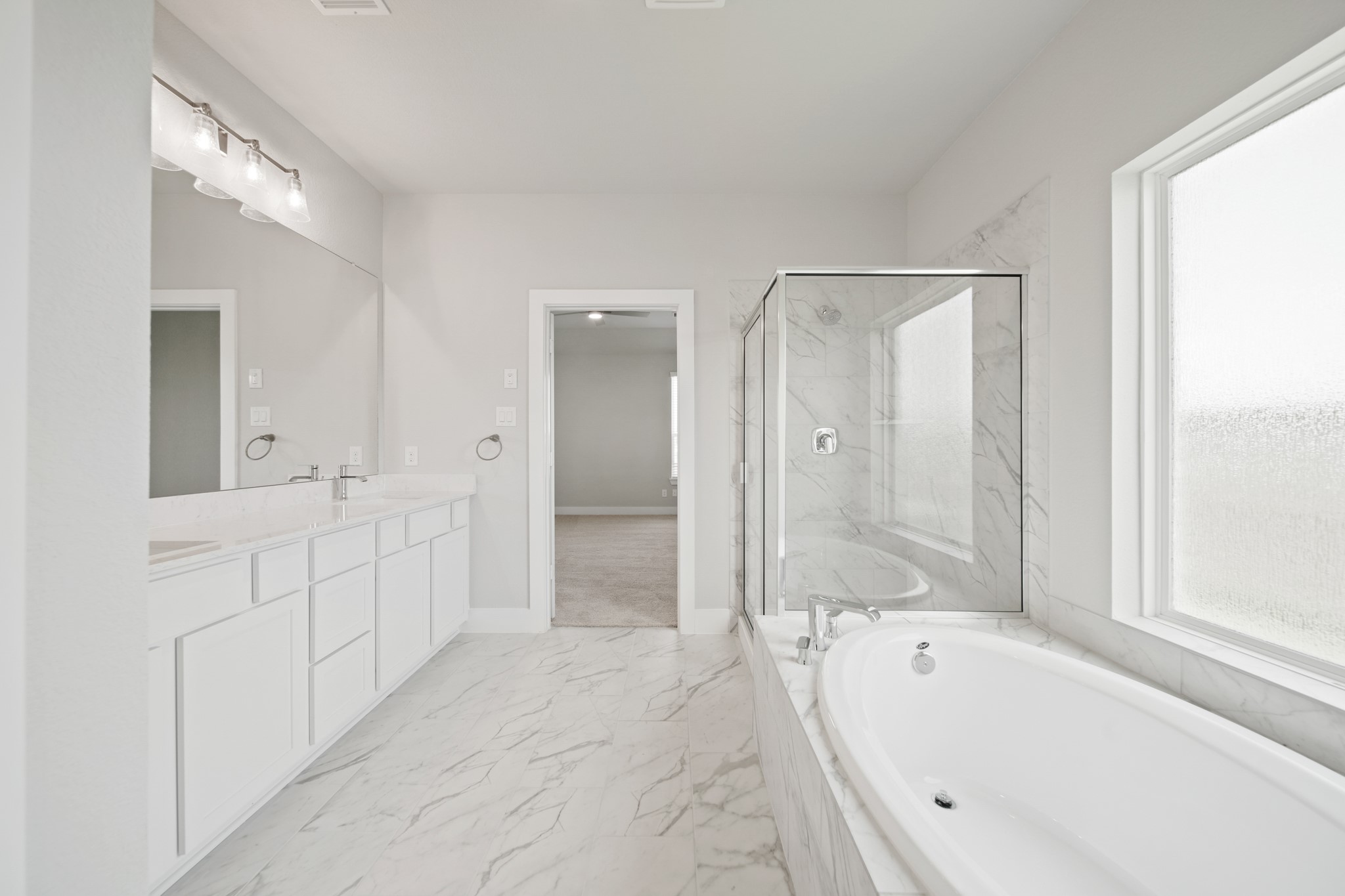 405 Hampton Edge Lane Waller, TX 77484 - Photo 20 of 45 a spacious bathroom with a tub shower sink and mirror