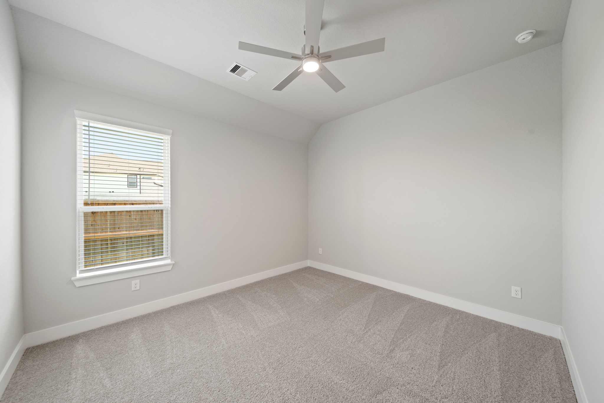 405 Hampton Edge Lane Waller, TX 77484 - Photo 21 of 45 an empty room with a window and a ceiling fan
