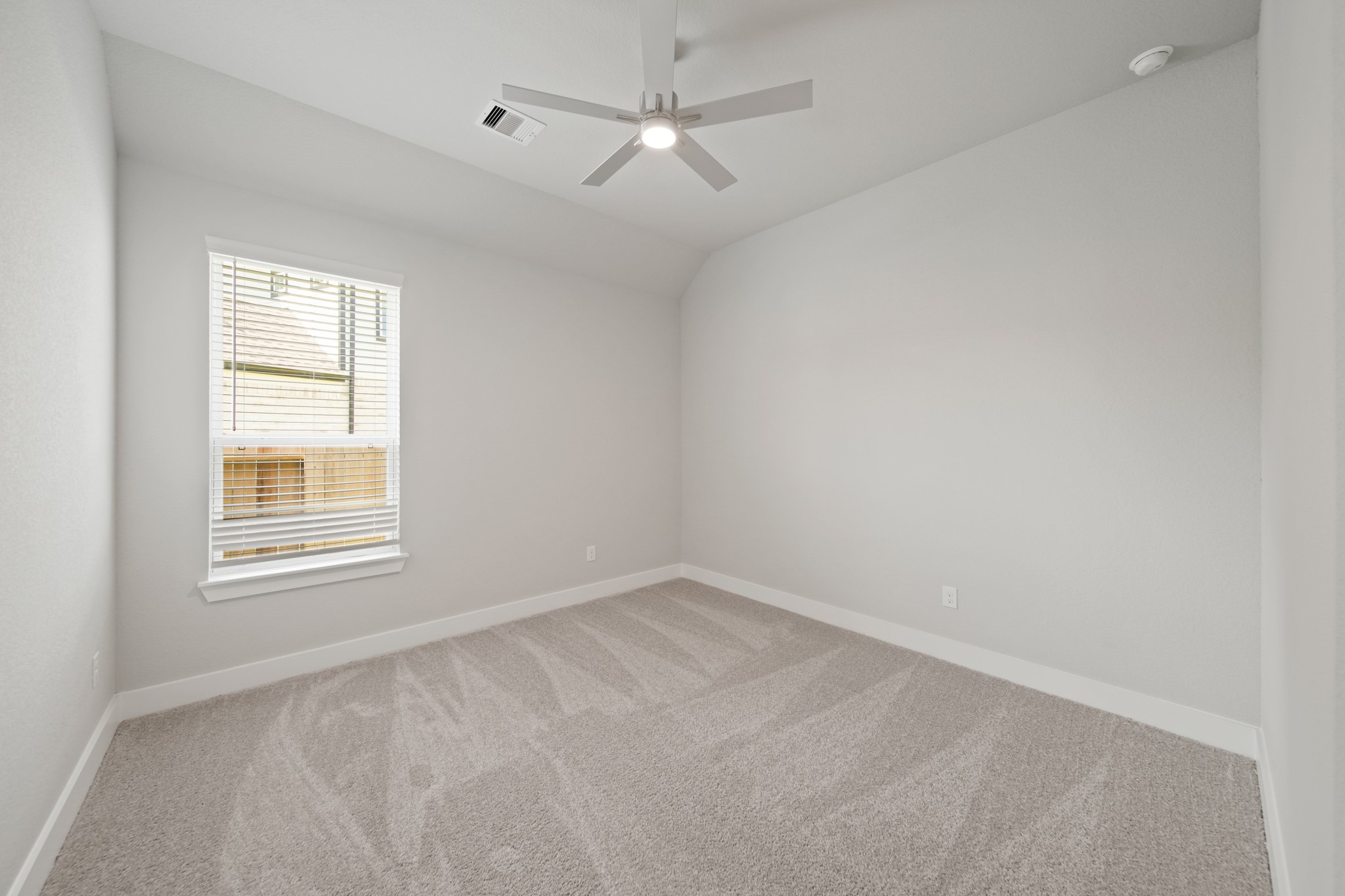 405 Hampton Edge Lane Waller, TX 77484 - Photo 24 of 45 an empty room with a window and a ceiling fan
