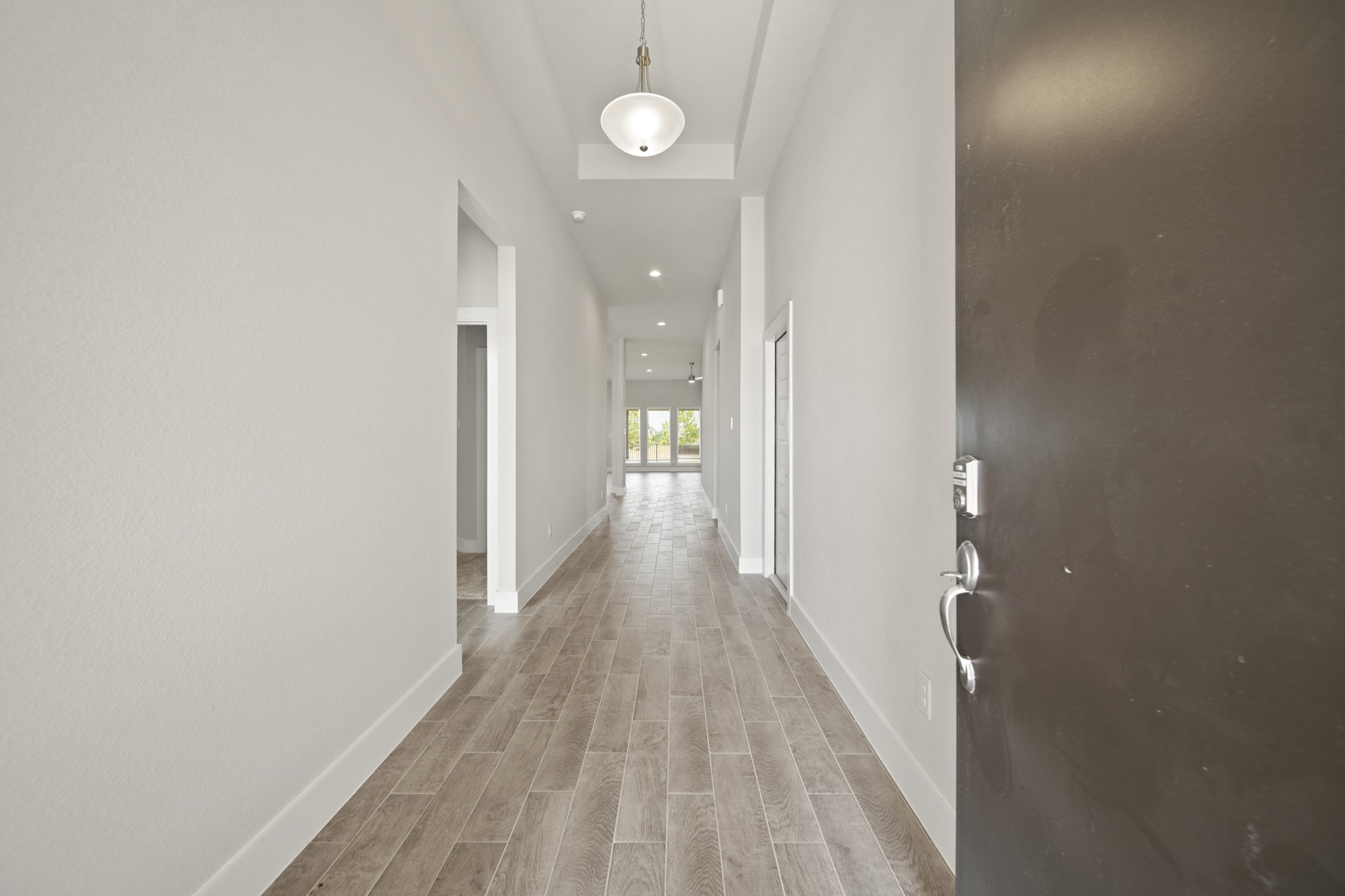 405 Hampton Edge Lane Waller, TX 77484 - Photo 4 of 45 a view of a hallway with wooden floor