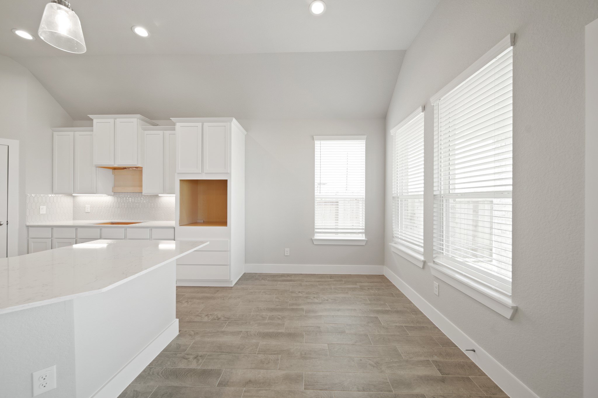 405 Hampton Edge Lane Waller, TX 77484 - Photo 7 of 45 a large white kitchen with cabinets and a window