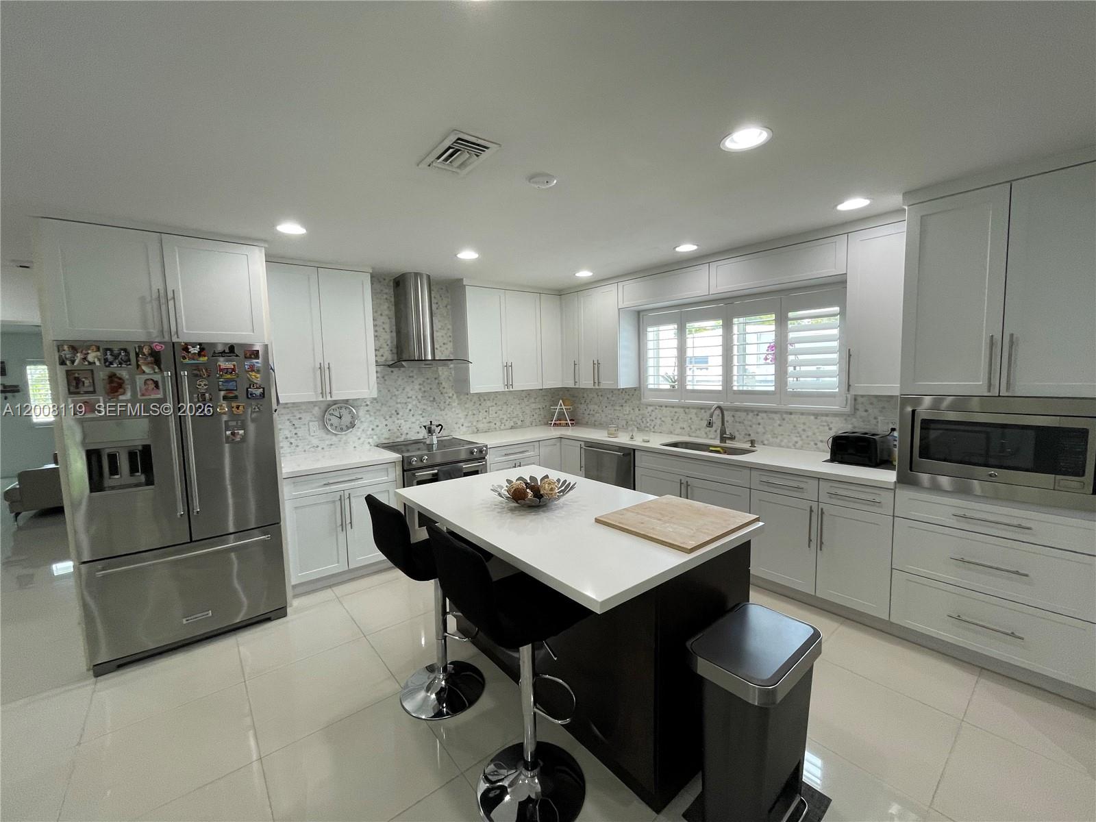 4161 Southwest 102nd Avenue Miami, FL 33165 - Photo 11 of 33 a kitchen with a sink a stove a refrigerator and cabinets