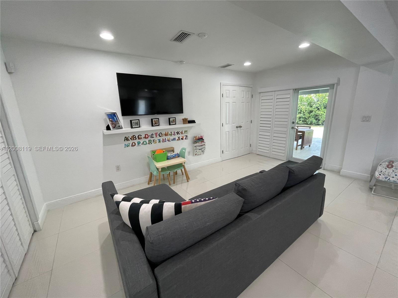 4161 Southwest 102nd Avenue Miami, FL 33165 - Photo 12 of 33 a living room with furniture and a flat screen tv