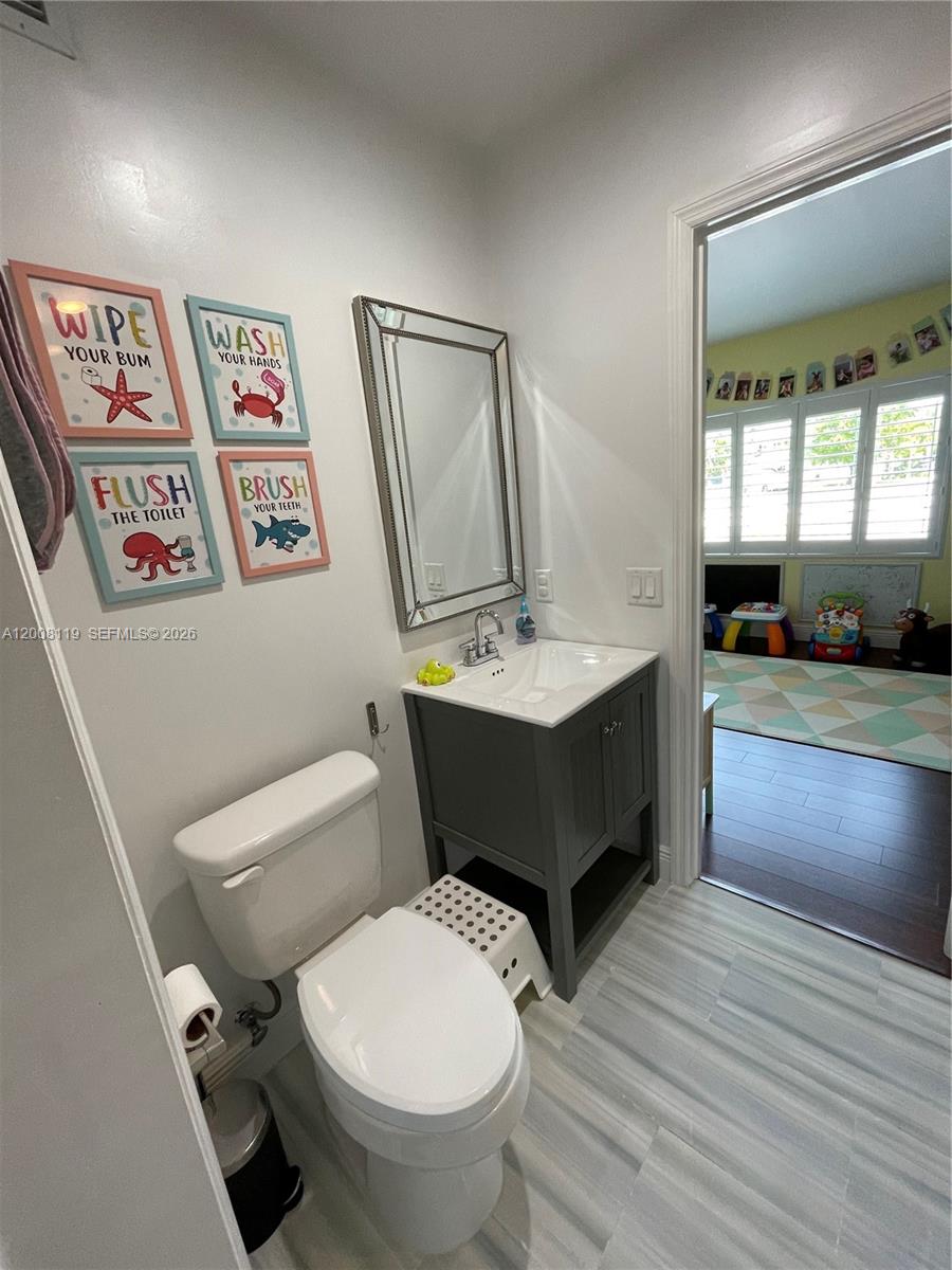 4161 Southwest 102nd Avenue Miami, FL 33165 - Photo 18 of 33 a bathroom with a sink mirror vanity and toilet