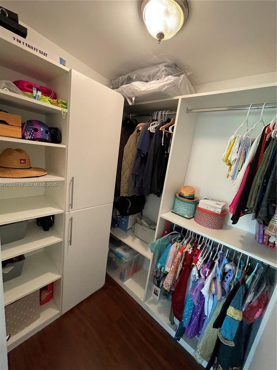 4161 Southwest 102nd Avenue Miami, FL 33165 - Photo 22 of 33 a view of walk in closet with clothes and shoes
