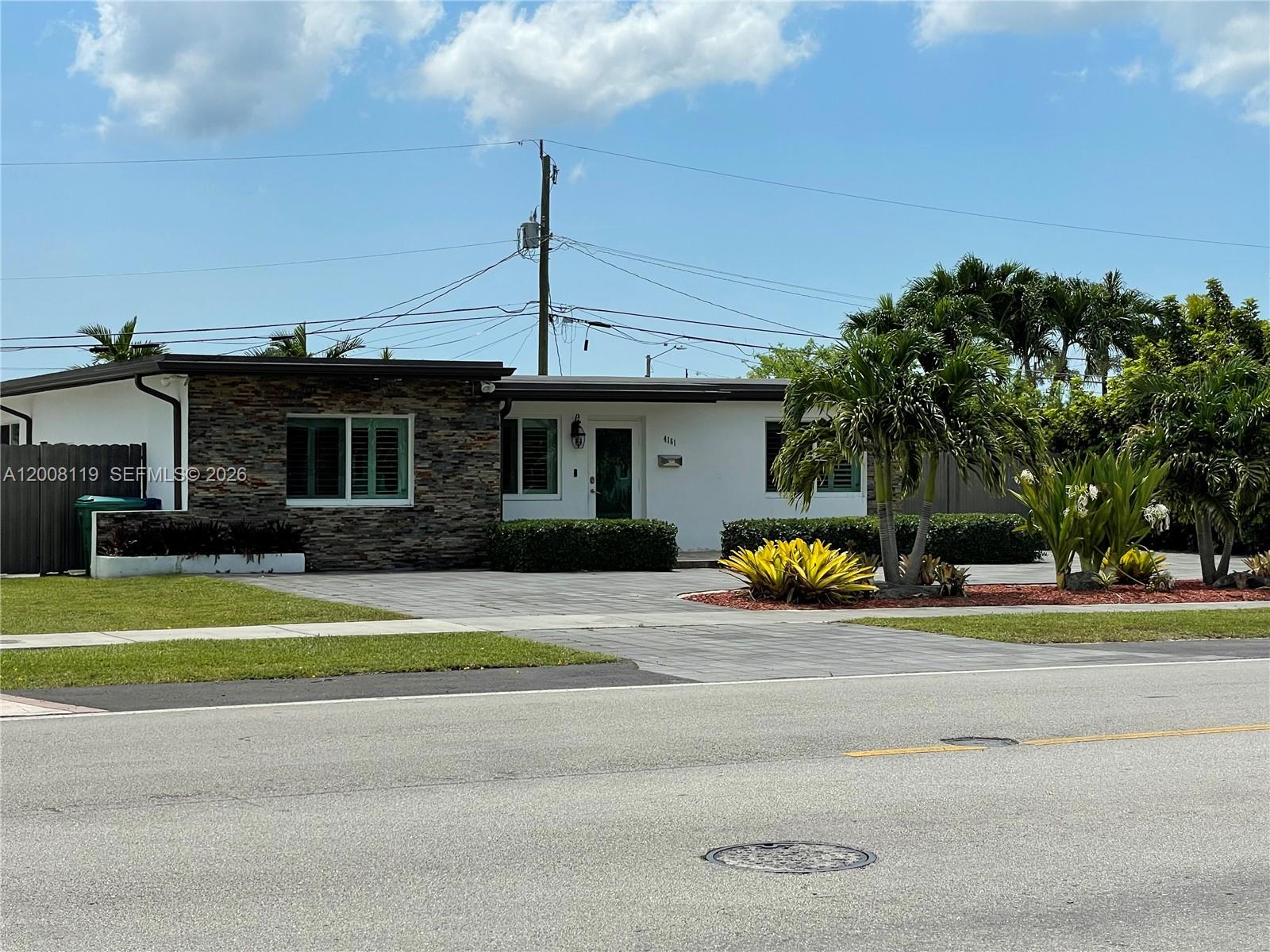 4161 Southwest 102nd Avenue Miami, FL 33165 - Photo 3 of 33 a view of a house with a swimming pool and a yard