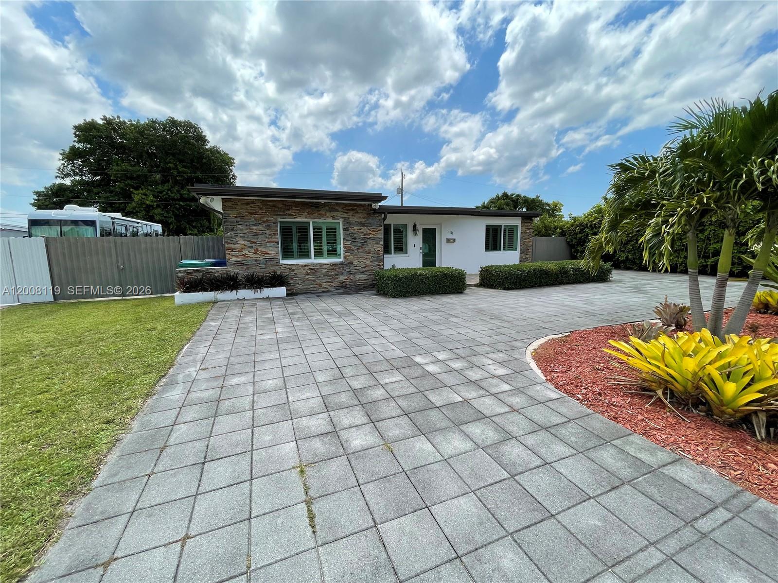 4161 Southwest 102nd Avenue Miami, FL 33165 - Photo 5 of 33 a view of a house with a rug and a fire pit