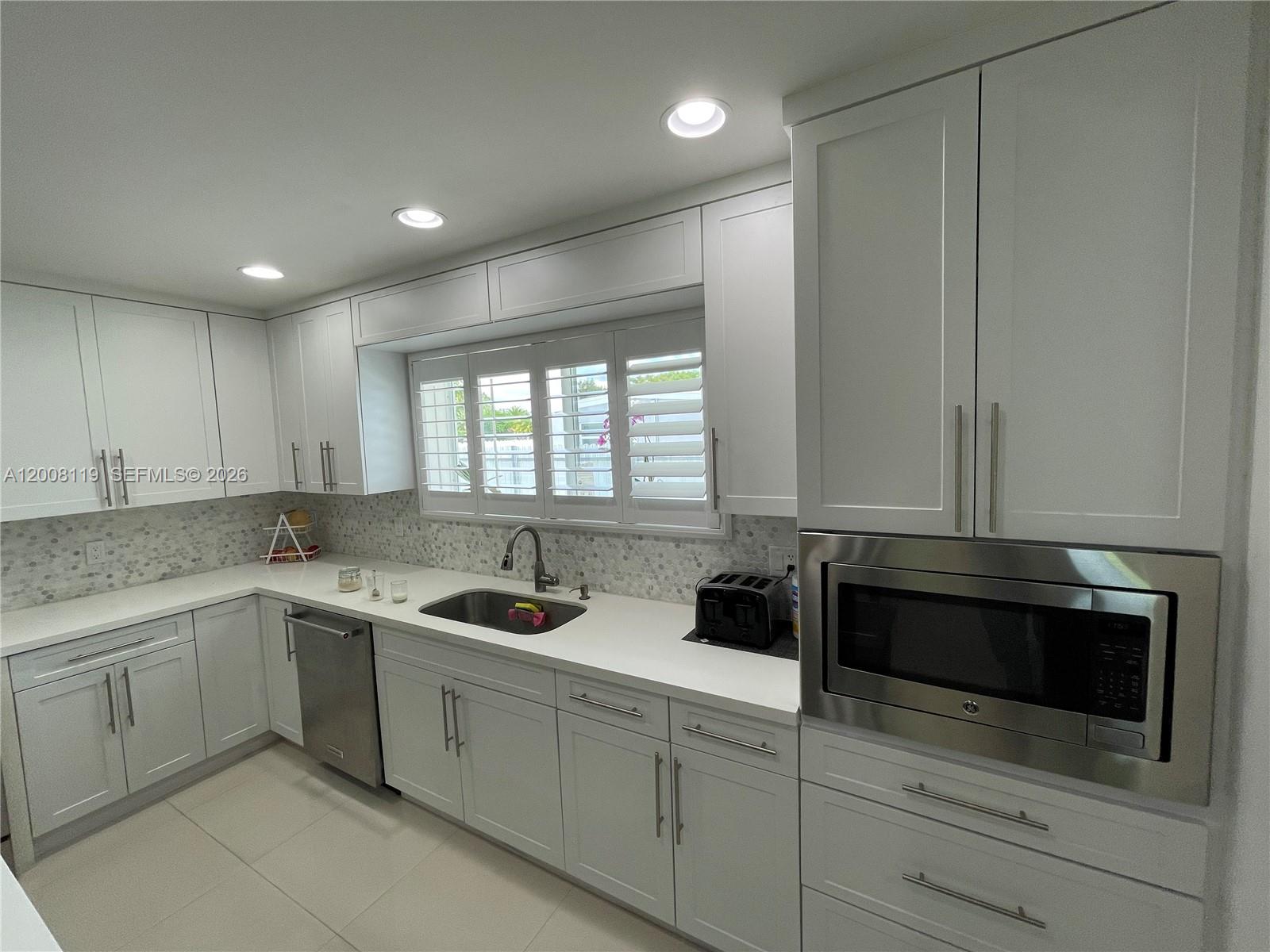 4161 Southwest 102nd Avenue Miami, FL 33165 - Photo 8 of 33 a kitchen with a sink and cabinets