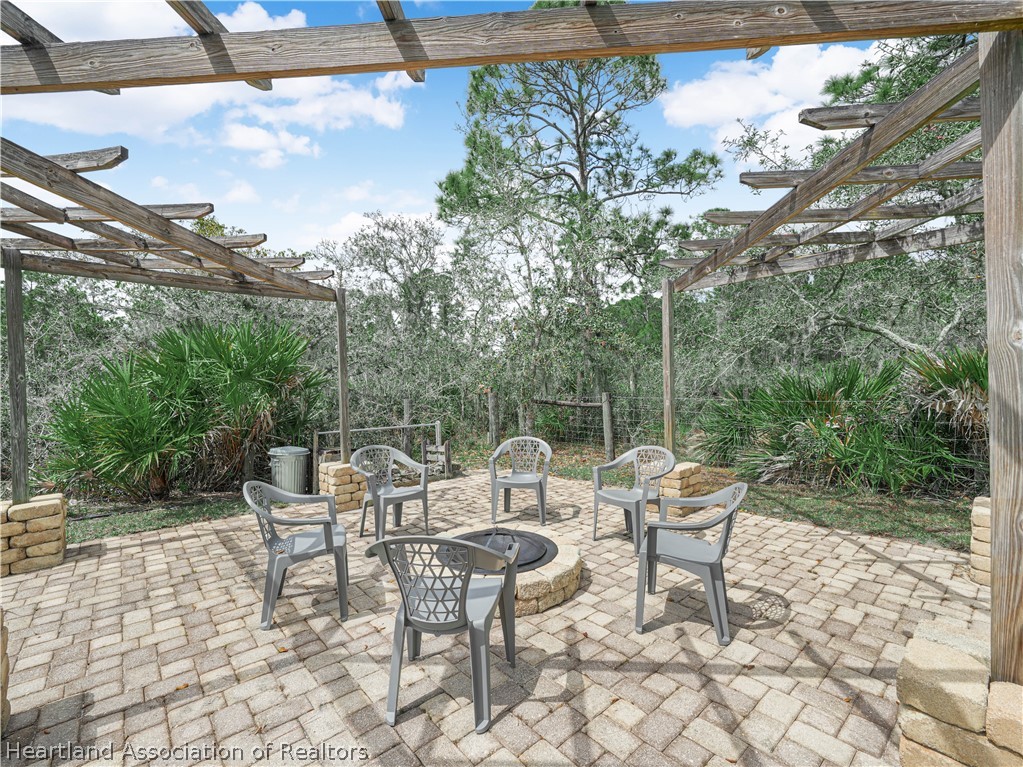 5721 Golden Road Sebring, FL 33875 - Photo 35 of 42 19x19 paver firepit (propane) seating area