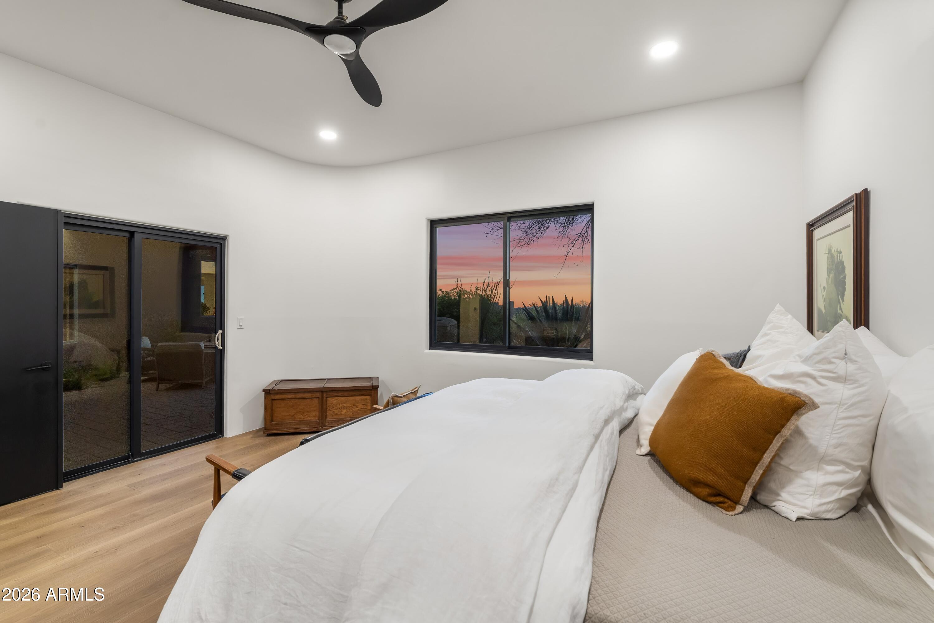 10046 East Hidden Valley Road Scottsdale, AZ 85262 - Photo 33 of 64 a bedroom with a bed and wooden floor