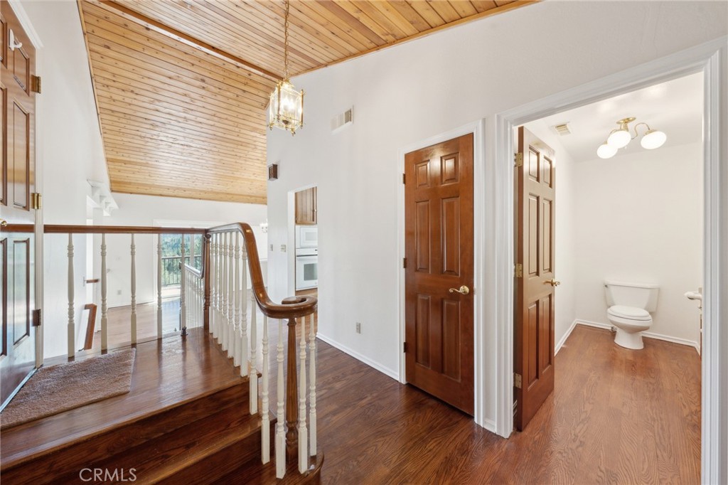 845 Sonoma Drive Lake Arrowhead, CA 92352 - Photo 14 of 49 a view of a hallway with wooden floor and stairs
