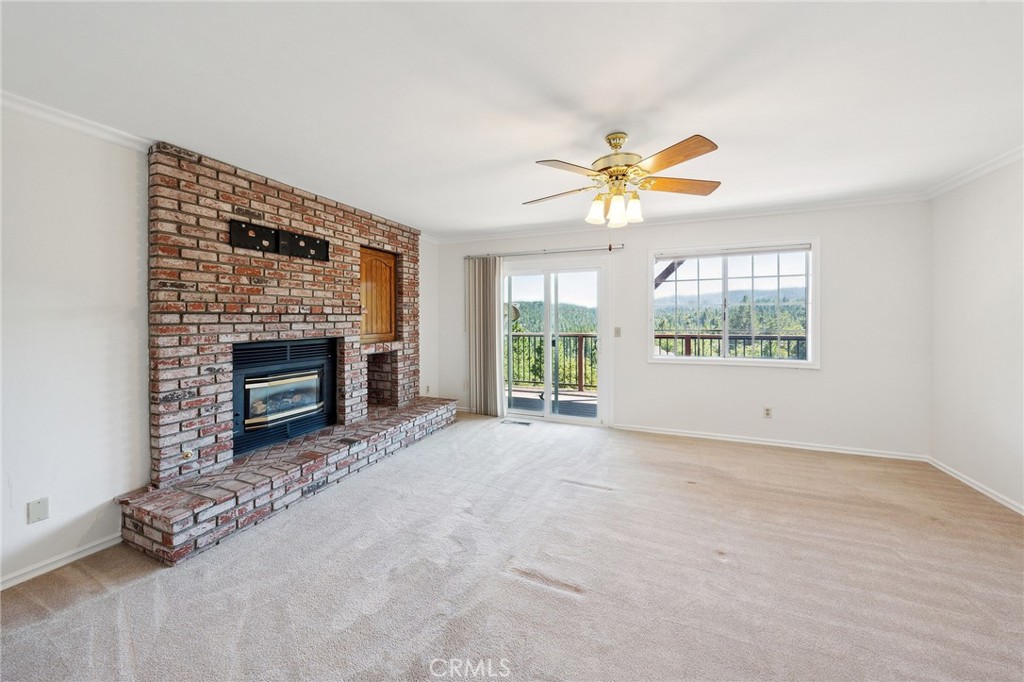845 Sonoma Drive Lake Arrowhead, CA 92352 - Photo 17 of 49 an empty room with windows and fireplace