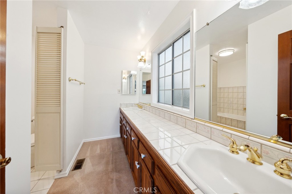 845 Sonoma Drive Lake Arrowhead, CA 92352 - Photo 20 of 49 a spacious bathroom with a granite countertop sink a mirror and a shower