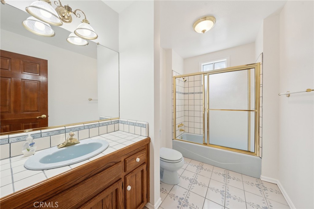845 Sonoma Drive Lake Arrowhead, CA 92352 - Photo 26 of 49 a spacious bathroom with a double vanity sink toilet and a mirror