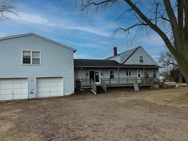 a view of a house with a yard and a car