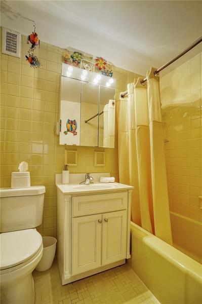 4625 Fifth Avenue, Unit 710 Pittsburgh, PA 15213 - Photo 12 of 12 a bathroom with a sink a toilet and shower