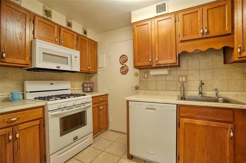 4625 Fifth Avenue, Unit 710 Pittsburgh, PA 15213 - Photo 8 of 12 a kitchen with stainless steel appliances granite countertop a sink a stove and cabinets