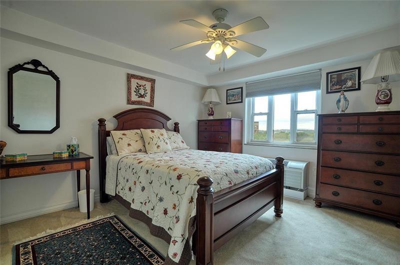 4625 Fifth Avenue, Unit 710 Pittsburgh, PA 15213 - Photo 10 of 12 a bedroom with a bed dresser and wooden floor