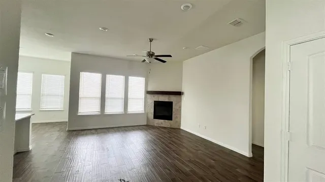 a view of kitchen with microwave a stove and wooden floor