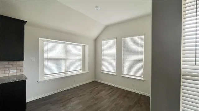a kitchen with stainless steel appliances granite countertop a sink and a microwave
