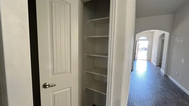 a kitchen with kitchen island granite countertop stainless steel appliances and wooden cabinets